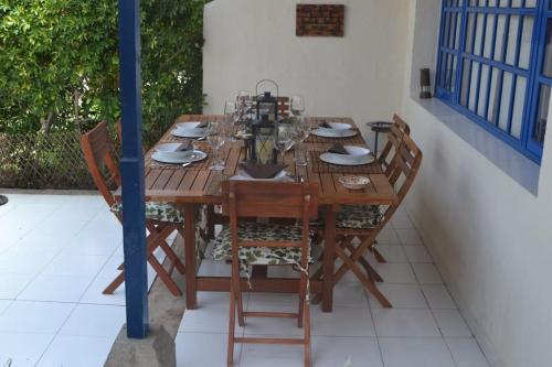 a wooden table and chairs on a patio at FABULOUS BUNGALOW , WIFI, SWIMMING POOL AND BEACH in Pasito Blanco