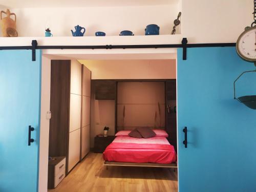 a bedroom with a bed and a open door at Sciara Eolie in Lipari