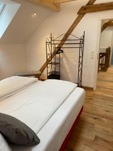 a white bed in a room with a staircase at Ferienhaus Endertsesel in Cochem