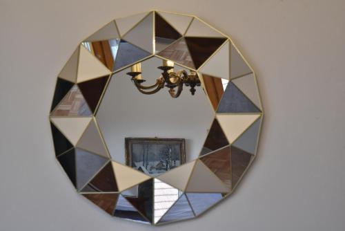 a mirror with a mosaic design on a wall at Apartmán s klavírem in Lednice