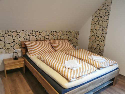 a bedroom with a bed with two towels on it at Naše Borovka in Borová Lada