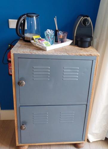 a blue dresser with a counter on top of it at Studio Pipper in Zandvoort