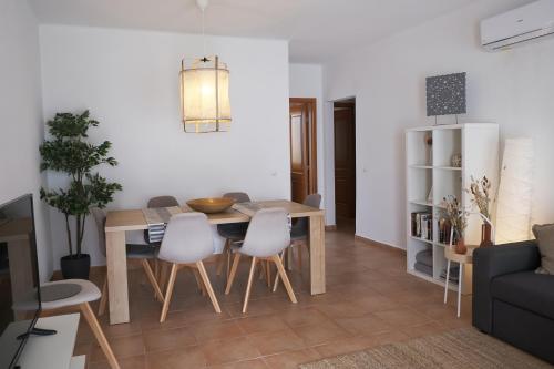 a kitchen and living room with a table and chairs at ML Central Vila Apartment in Carvoeiro
