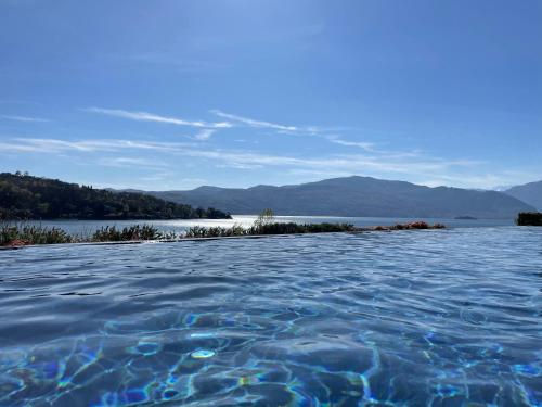 a pool of water with a view of a lake at BrixHome in Laveno-Mombello