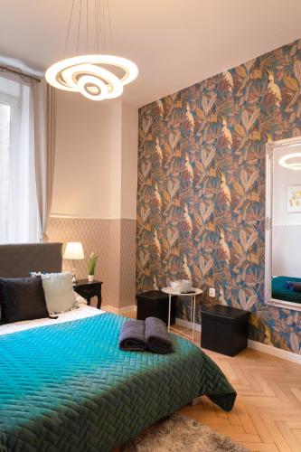 a bedroom with a large bed with a blue blanket at ClickTheFlat Aleje Jerozolimskie Center Apart Rooms in Warsaw
