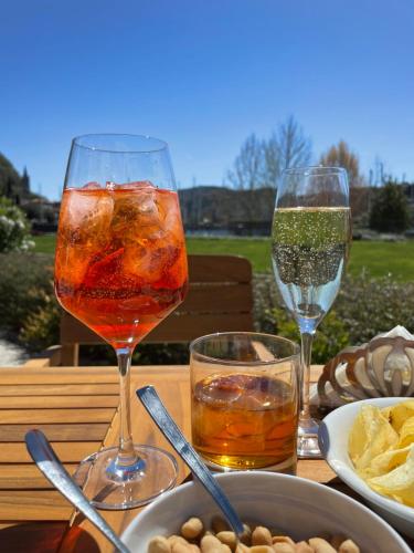 a table with two glasses of wine and some food at BrixHome in Laveno-Mombello