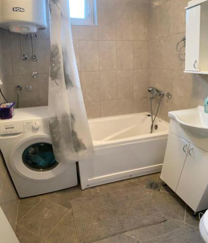 a bathroom with a tub and a toilet and a sink at Apartment Ana Milena in Kolonija