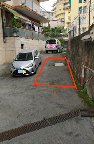 two cars are parked in a parking lot at I love Rapallo La casa AlMar in Rapallo
