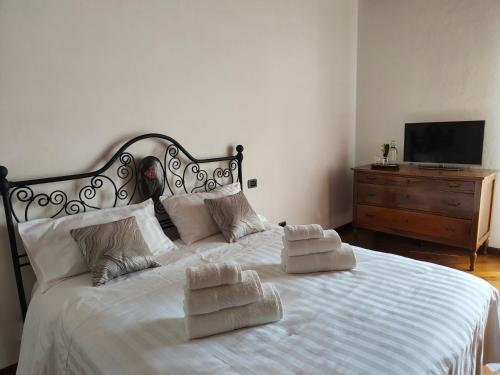 a bedroom with a white bed with towels on it at B&B Villa Letizia in San Vito Rimini