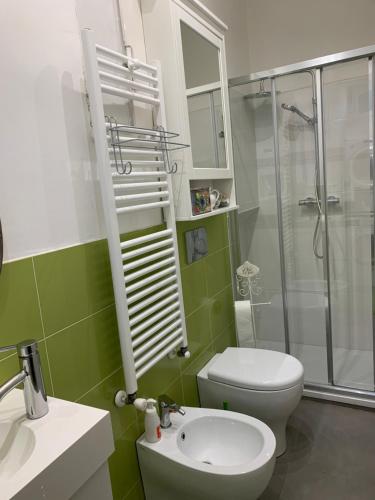a bathroom with a toilet and a shower and a sink at Maria Vittoria House in Turin