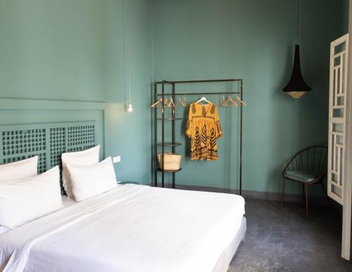 a bedroom with a large white bed and a chair at Numa Marrakech in Marrakech