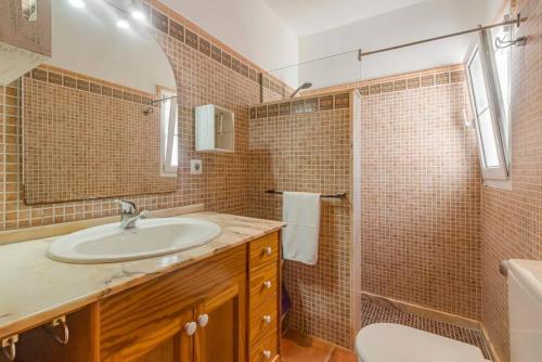 a bathroom with a sink and a shower and a toilet at Villa Mica in Son Carrio