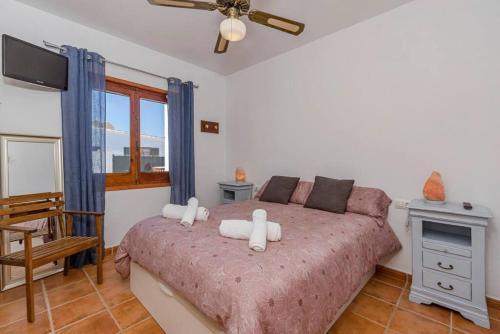 a bedroom with a bed with white towels on it at Villa Mica in Son Carrio