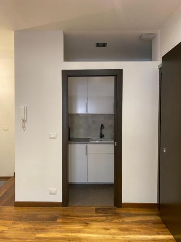 uma porta aberta para uma cozinha com um lavatório em Nice104 em Turim