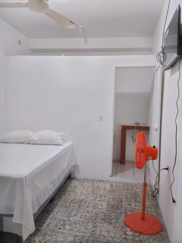 a bedroom with a bed and a red fire hydrant at Hotel Villa Aurora in Flores