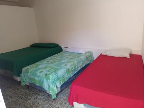 two beds sitting next to each other in a room at Hotel Villa Aurora in Flores