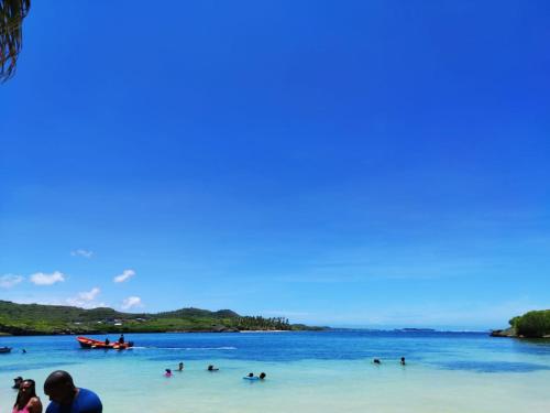 a group of people in the water at a beach at Refuge et Bellevue in Sainte-Luce