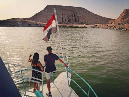 a man and a woman on a boat with a flag at Safari Abu Simbel in Abu Simbel
