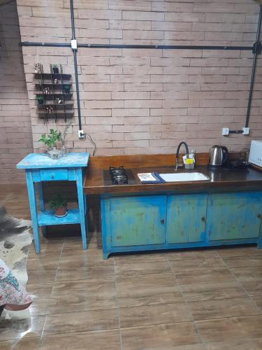 a kitchen with a blue island with a sink at Sossego do Interior III in Nova Petrópolis