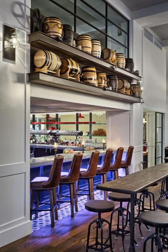 a restaurant with a table and chairs and a bar at Hotel Teatro in Denver