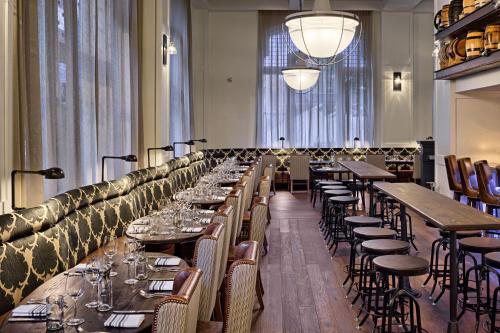 a row of tables and chairs in a restaurant at Hotel Teatro in Denver