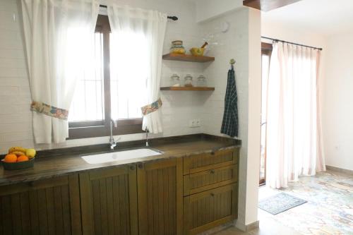 a kitchen with a sink and a window at Casa Sant Vicent 63 in Teulada