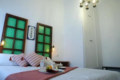 a bedroom with a bed with a tray of food on it at Casa Sant Vicent 63 in Teulada