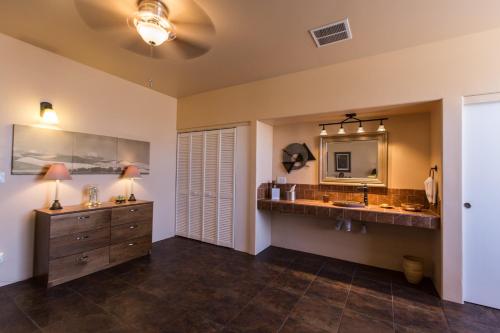 a bathroom with two sinks and a large mirror at Turtle Back Mesa Bed and Breakfast in Indio