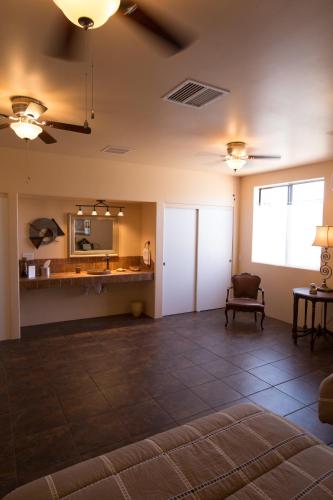 an empty room with a couch and a table at Turtle Back Mesa Bed and Breakfast in Indio