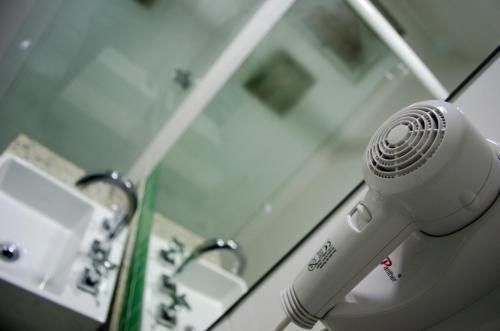 a hair dryer sitting in a hospital room at Hotel Gomes Freire (Adult Only) in Rio de Janeiro