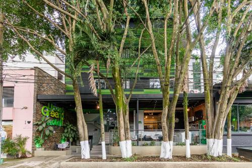 a group of trees in front of a building at Lleras Green Hotel in Medellín