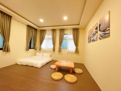 a bedroom with a bed and a wooden table at City of Trees B&B in Sanxia