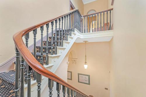 a spiral staircase with wooden railings in a house at Clocktower Suites in Echuca