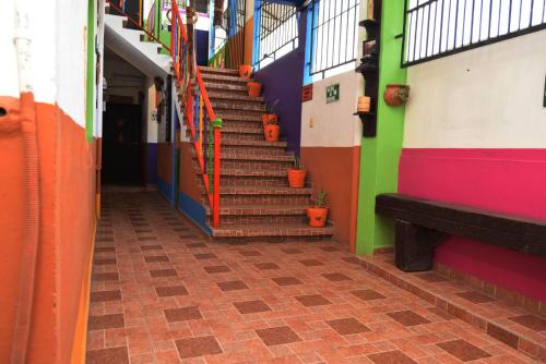 a hallway with stairs in a building with colorful walls at Kali Huasteca Posada in Ciudad Valles