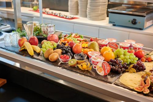 a bunch of fruits and vegetables on a buffet at MY HOME Hotel Lamm Rottweil "Smart Home" in Rottweil