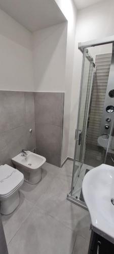 a bathroom with a toilet and a sink and a shower at LA NUOVA HERA in Crotone