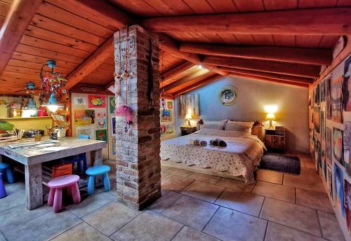 a bedroom with a bed and a table in it at Xenonerantzia Country style villa in Gouvia