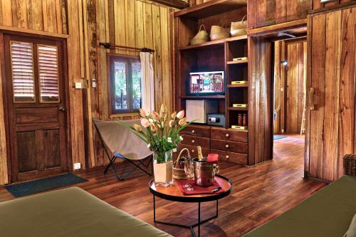 a living room with a table with flowers on it at Sok San Beach Resort in Koh Rong Island