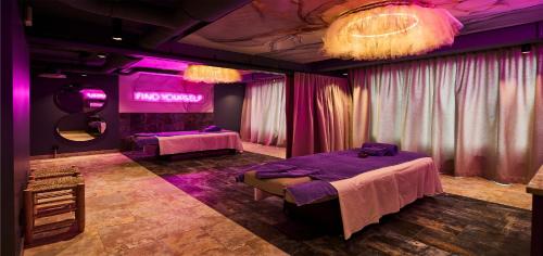 a room with two beds and purple lighting at Urban Nature St Peter-Ording in Sankt Peter-Ording