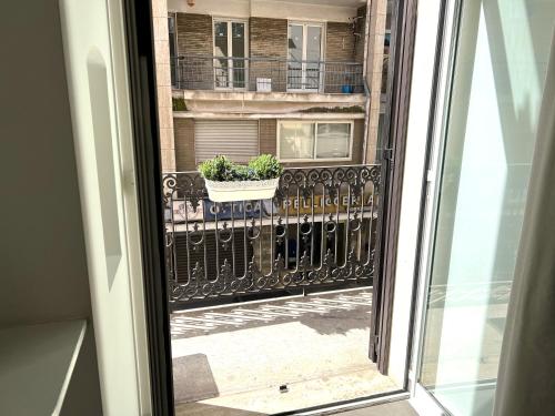 okna z widokiem na balkon z rośliną w obiekcie Bienvenue 3 w mieście Bari