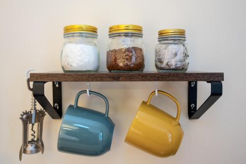 a shelf with three jars of food and a purse at The Ramblers' Rest - Princetown in Princetown