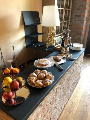 a table with plates of bread and fruit on it at Cascina Bo in Canelli