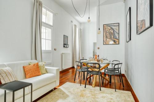 a living room with a white couch and a table at Irundo Downtown Apartments in Zagreb