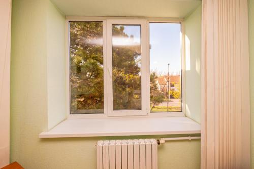 a window in a room with a radiator in front of it at Elektromash Hotel in Tiraspol