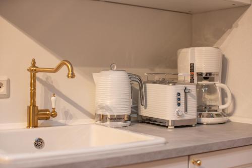 a kitchen counter with a sink and a appliance at ApartOne Palais-Apartments in Bautzen