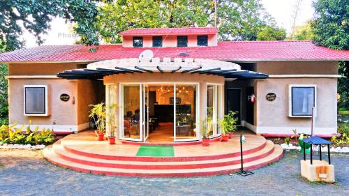 a house with a revolving door in front of it at Bundela Bandhavgarh by Octave in Mānpur