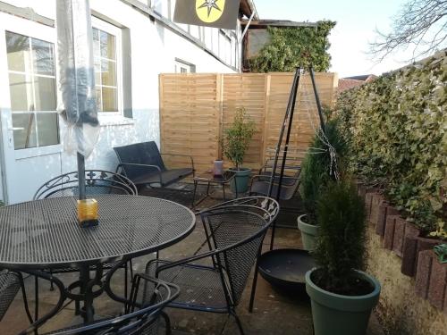 a patio with tables and chairs and a fence at Group Haus Blick am Edersee 13P in Waldeck