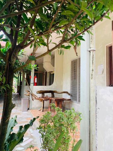 a wooden bench sitting outside of a building at Pisces Tourist Inn - Port Barton in San Vicente