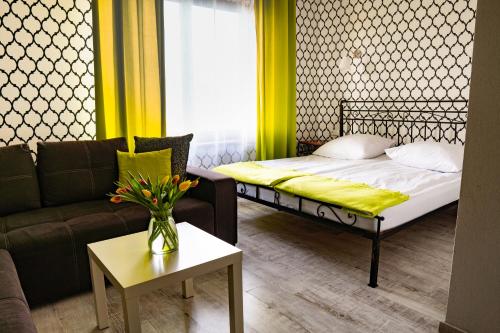 マワ・ニエシャフカにあるRanchoのベッド、ソファ、テーブルが備わる客室です。