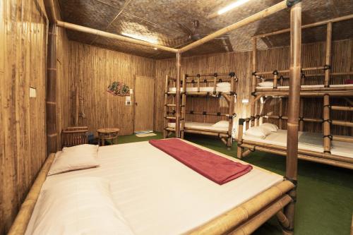 a bedroom with a bed and a desk at Tadom Hill Resorts in Kampong Labohan Dagang